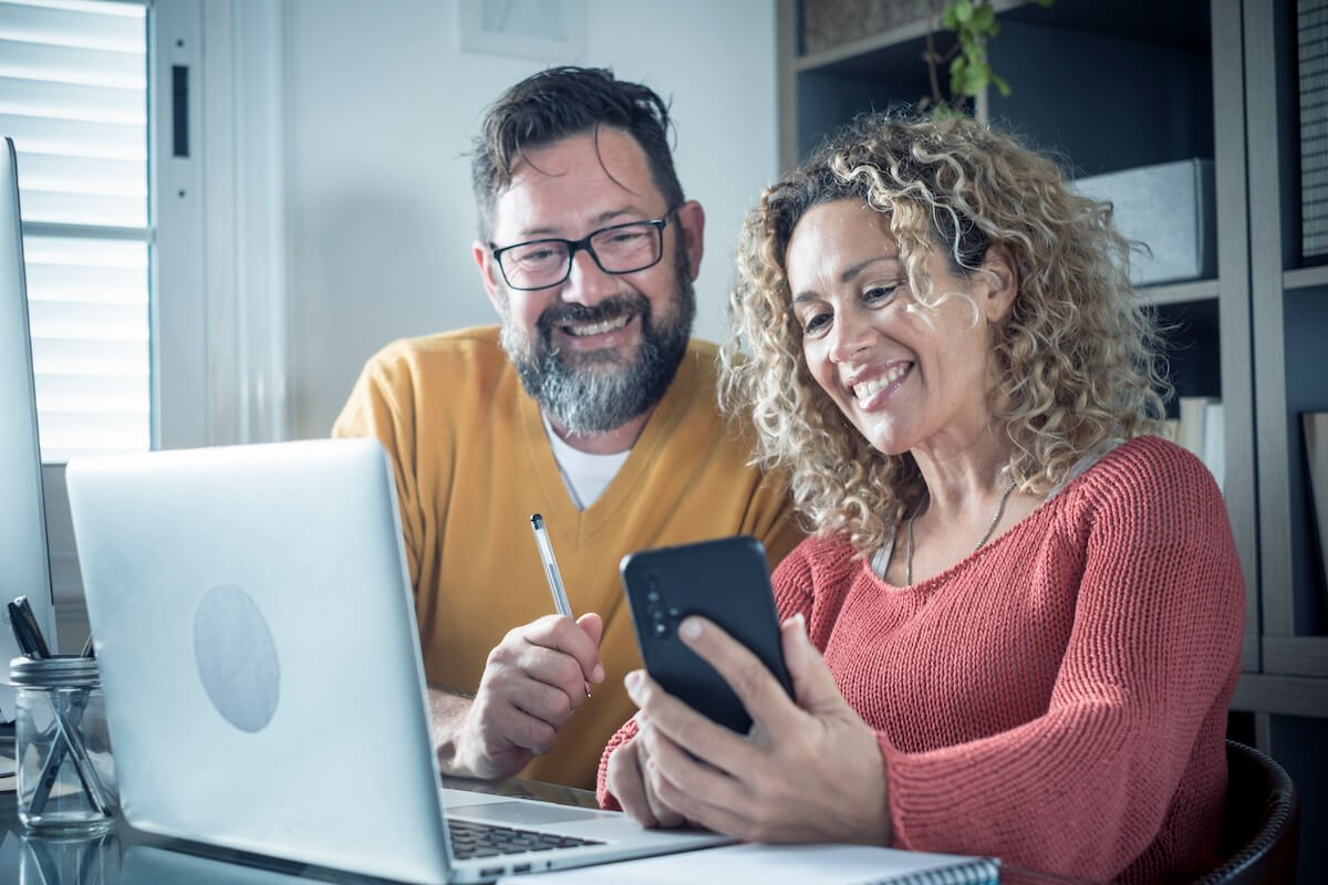 couple smiling as they look at their retirement spending plan